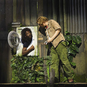 Vader Fantastic praat tegen iemand die in een wasmachine zit en daaruit z'n hoofd naar buiten steekt.