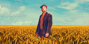 Een man in een uitgestrekt graanveld